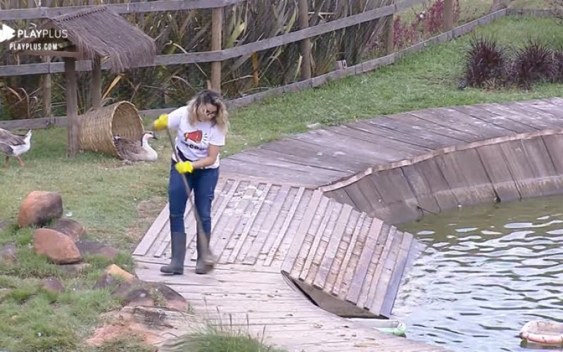 Diego Grossi ajuda Thayse Teixeira na limpeza do lago dos gansos